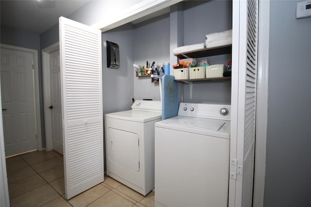 washroom with laundry area, light tile patterned floors, and independent washer and dryer