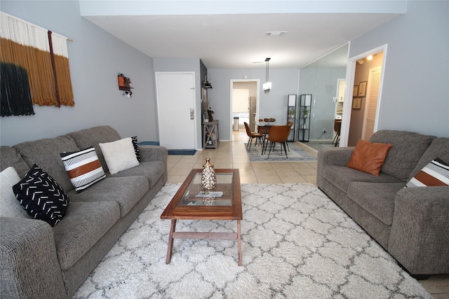 tiled living room featuring visible vents