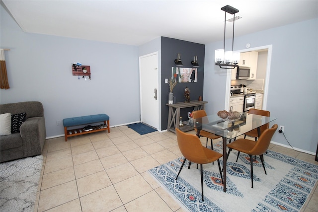 dining area with light tile patterned floors, baseboards, visible vents, and an inviting chandelier