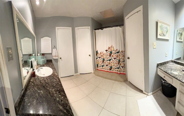 bathroom featuring tile patterned floors, curtained shower, and vanity