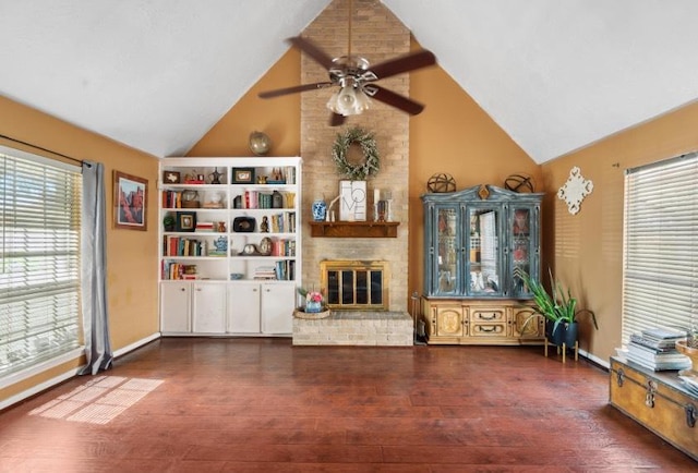 unfurnished living room featuring a brick fireplace, baseboards, wood finished floors, high vaulted ceiling, and a ceiling fan