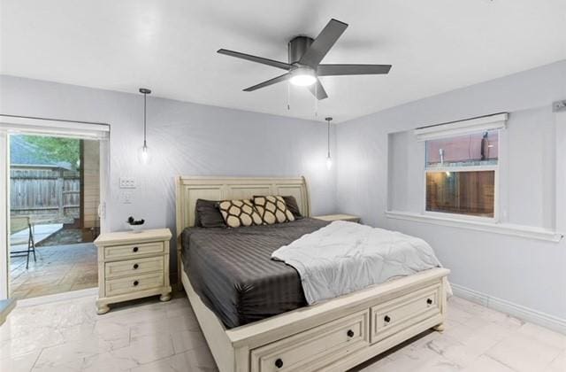 bedroom with access to exterior, marble finish floor, ceiling fan, and baseboards