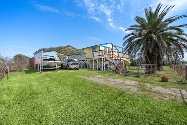 back of property featuring a yard, a gate, fence, a carport, and driveway