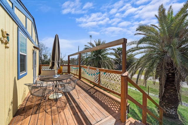 wooden deck featuring outdoor dining area