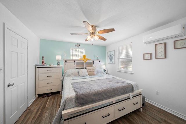 bedroom featuring ceiling fan, a wall mounted AC, dark wood finished floors, and baseboards