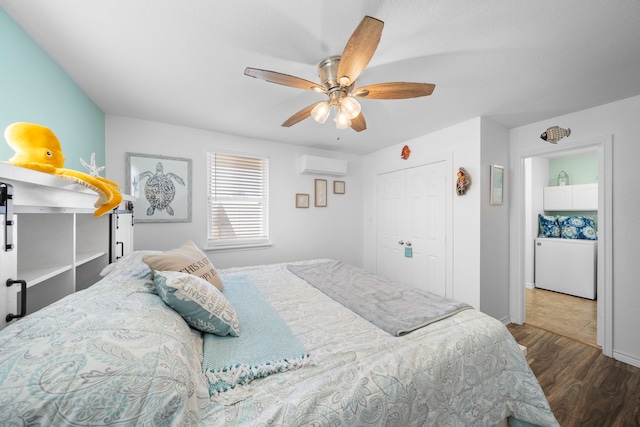 bedroom with a ceiling fan, a closet, a wall mounted air conditioner, and wood finished floors