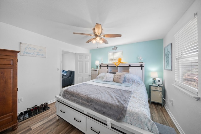 bedroom featuring dark wood-style floors, ceiling fan, and baseboards