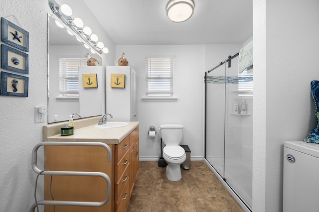 bathroom with baseboards, a healthy amount of sunlight, a shower stall, and toilet