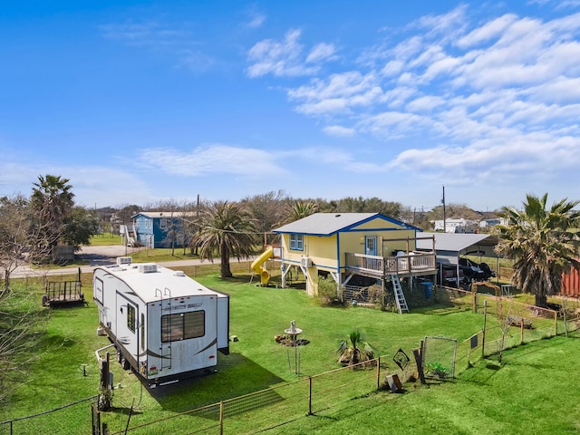 rear view of house featuring fence private yard, stairway, a deck, and a yard