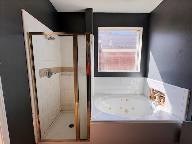 bathroom featuring a jetted tub and a stall shower