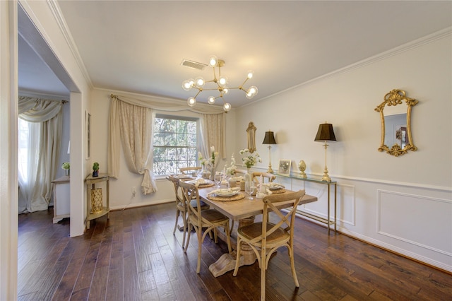 dining room featuring ornamental molding, hardwood / wood-style flooring, visible vents, and an inviting chandelier