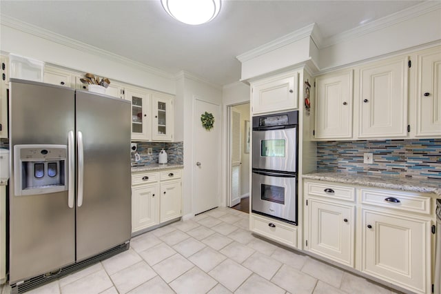 kitchen with tasteful backsplash, stainless steel appliances, and crown molding