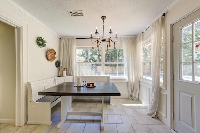 dining space with light tile patterned floors, visible vents, an inviting chandelier, crown molding, and a textured ceiling