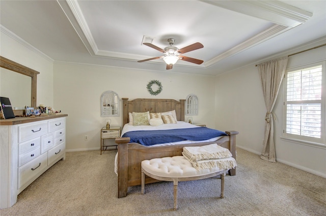 bedroom featuring ornamental molding, a raised ceiling, and light colored carpet