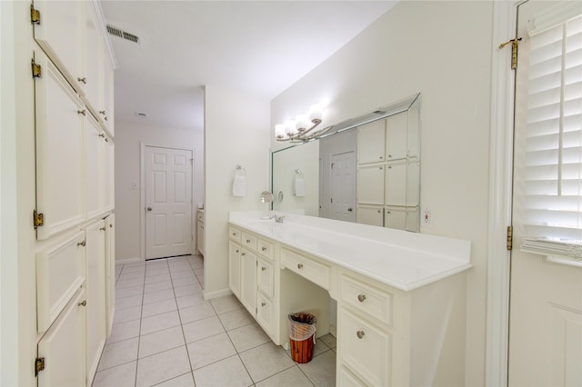 bathroom with tile patterned flooring, visible vents, vanity, and baseboards