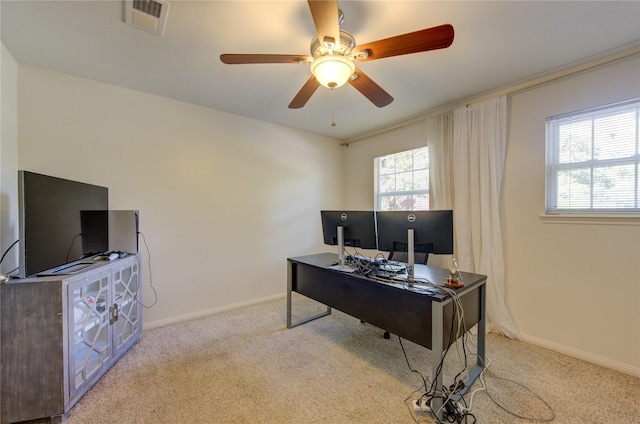 office space with carpet floors, baseboards, visible vents, and ceiling fan