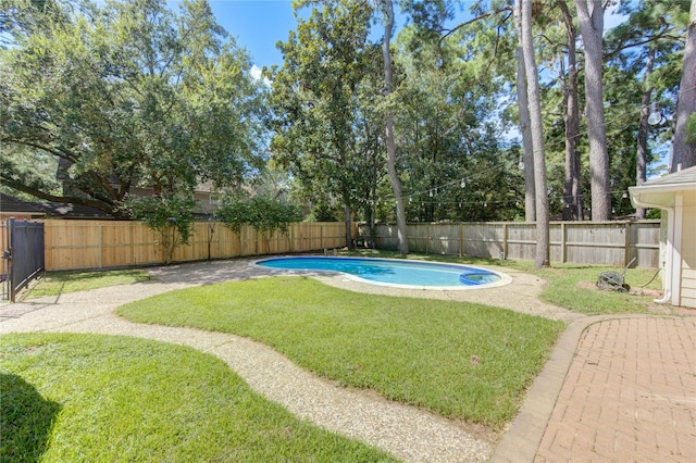 view of pool with a fenced in pool, a fenced backyard, and a lawn