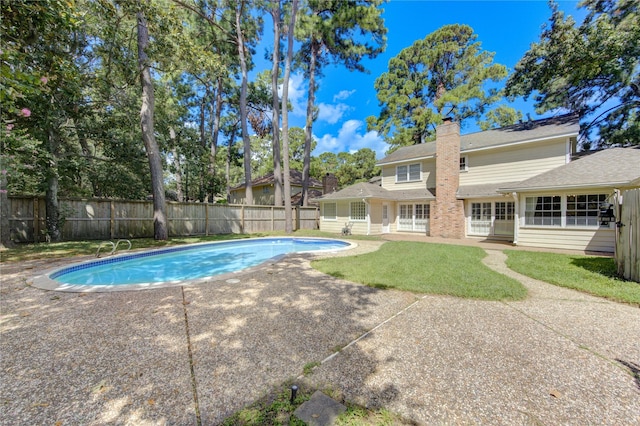 view of pool featuring a patio, a yard, a fenced backyard, and a fenced in pool