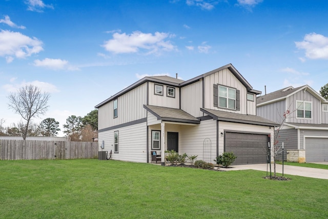 view of front of property with concrete driveway, an attached garage, fence, board and batten siding, and a front yard