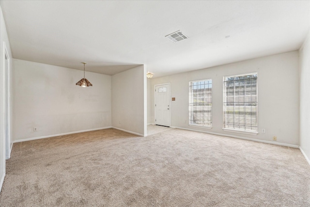 unfurnished room featuring carpet flooring, baseboards, and visible vents