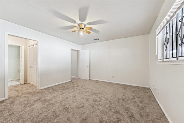 unfurnished room featuring visible vents, baseboards, ceiling fan, and carpet flooring