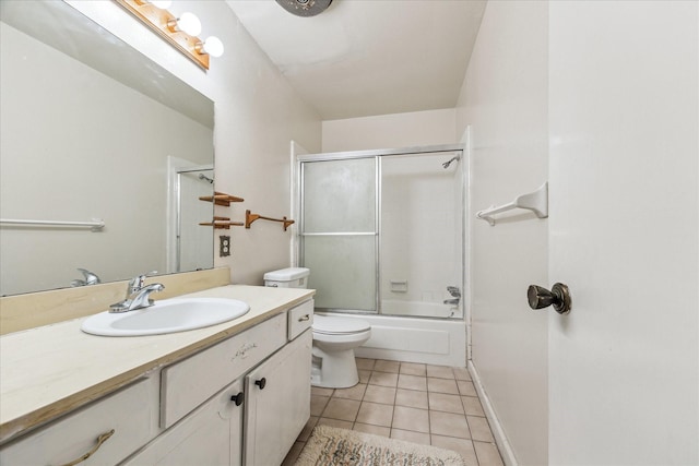 full bath featuring tile patterned floors, toilet, shower / bath combination with glass door, baseboards, and vanity