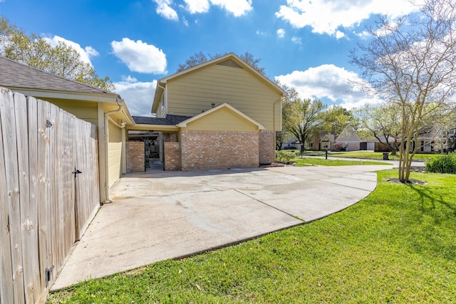 view of side of property with a lawn and brick siding