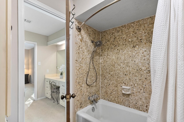 bathroom with visible vents, vanity, and shower / tub combo