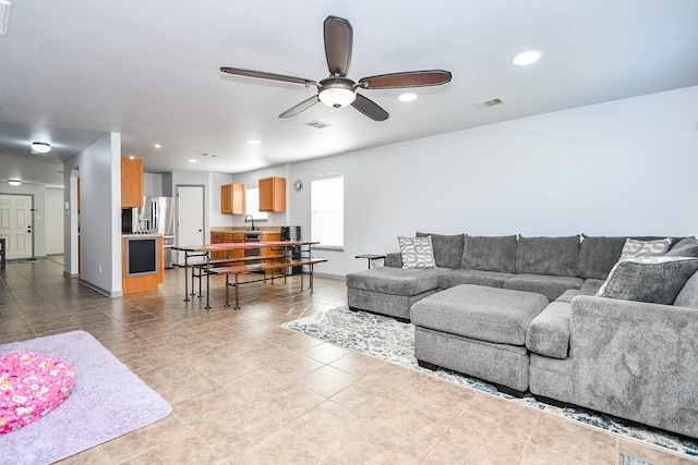 living room featuring a ceiling fan, recessed lighting, visible vents, and tile patterned floors