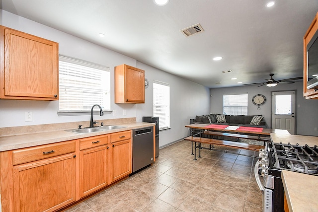 kitchen with a wealth of natural light, visible vents, appliances with stainless steel finishes, open floor plan, and a sink