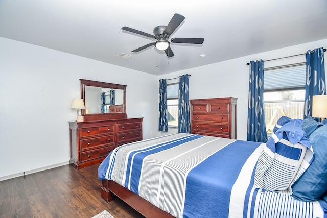 bedroom with a ceiling fan, visible vents, multiple windows, and wood finished floors