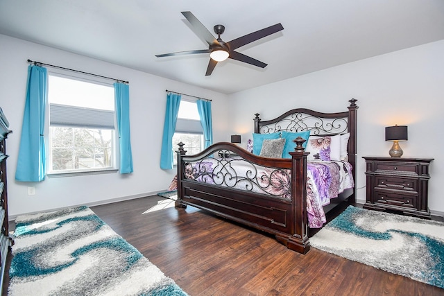 bedroom featuring a ceiling fan, baseboards, and wood finished floors