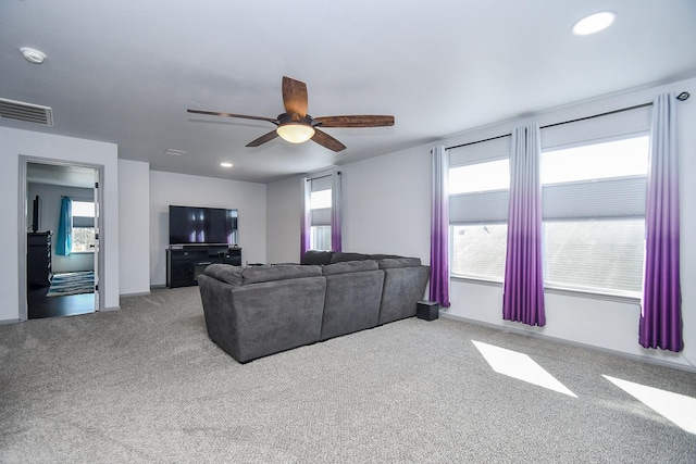 carpeted living area with ceiling fan, visible vents, baseboards, and recessed lighting