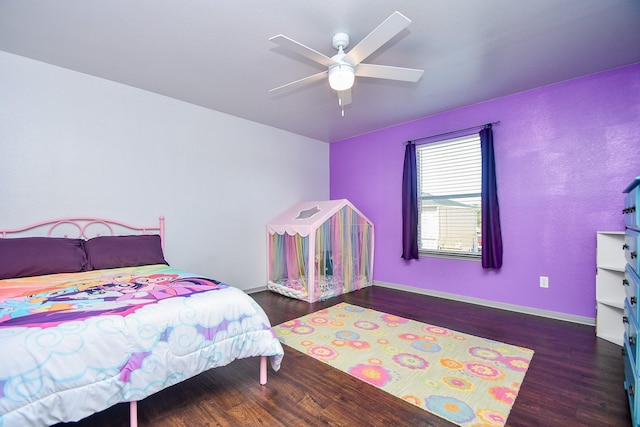 bedroom featuring a ceiling fan, baseboards, and wood finished floors