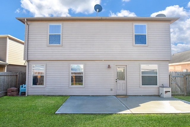 rear view of house with a fenced backyard, a patio, and a yard