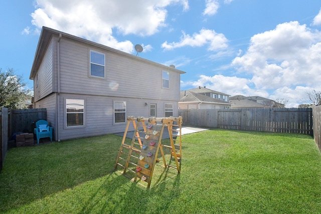 back of property with a lawn, a patio area, and a fenced backyard