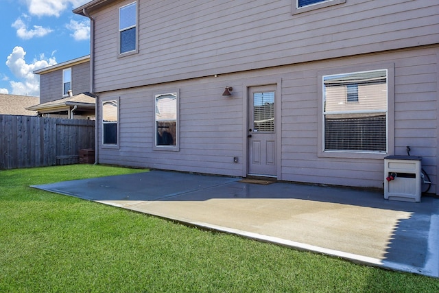 back of house with a yard, a patio area, and fence