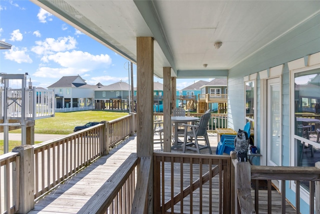 deck featuring a yard and a residential view