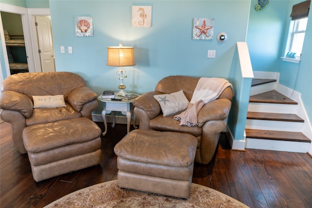 living room featuring stairway, wood-type flooring, and baseboards