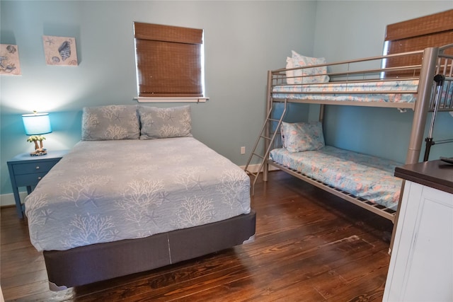 bedroom with baseboards and wood finished floors