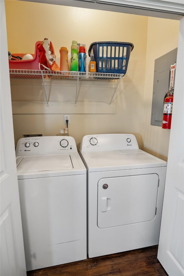 laundry area featuring dark wood-style flooring, laundry area, and washing machine and clothes dryer