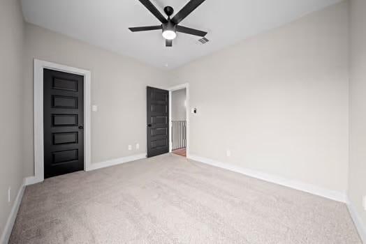 unfurnished bedroom featuring visible vents, baseboards, ceiling fan, and carpet flooring