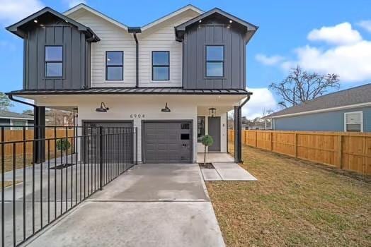 view of front of property featuring board and batten siding and fence