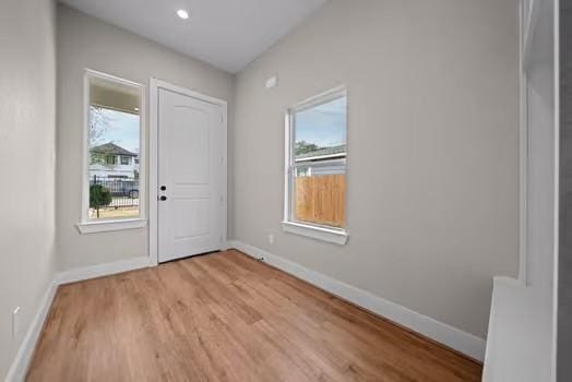 foyer featuring light wood-type flooring and baseboards