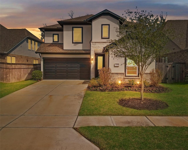 view of front of property with a front yard, fence, stucco siding, a garage, and stone siding