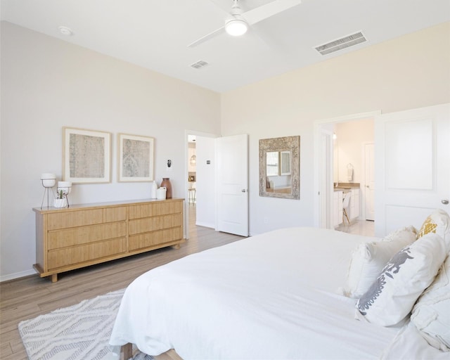 bedroom featuring visible vents, ensuite bath, light wood-style flooring, and a ceiling fan