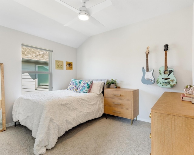 bedroom with baseboards, light colored carpet, ceiling fan, and vaulted ceiling