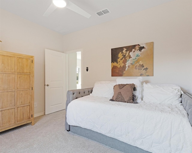 bedroom with visible vents, light carpet, baseboards, and a ceiling fan