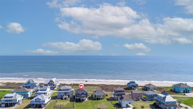 birds eye view of property featuring a water view, a view of the beach, and a residential view