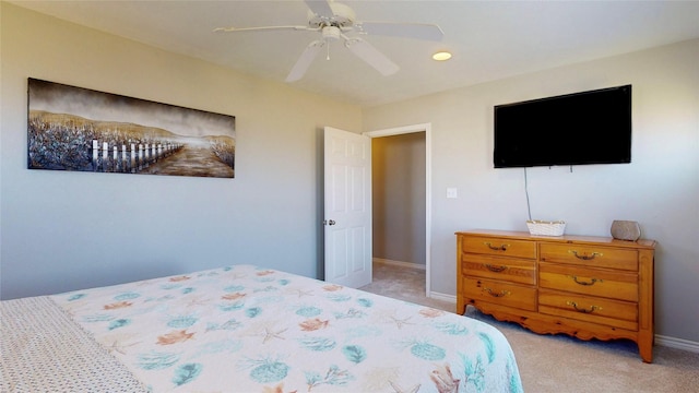 bedroom with light colored carpet, ceiling fan, and baseboards